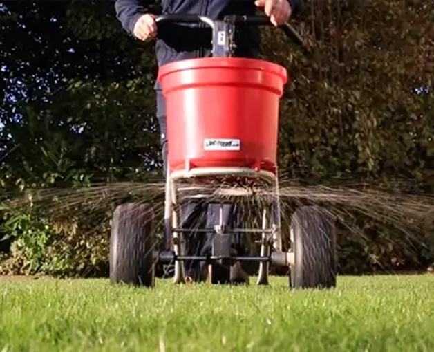 Back Garden with children's shoots and playthings.  The grass has punctured holes in it, this is the aeration process