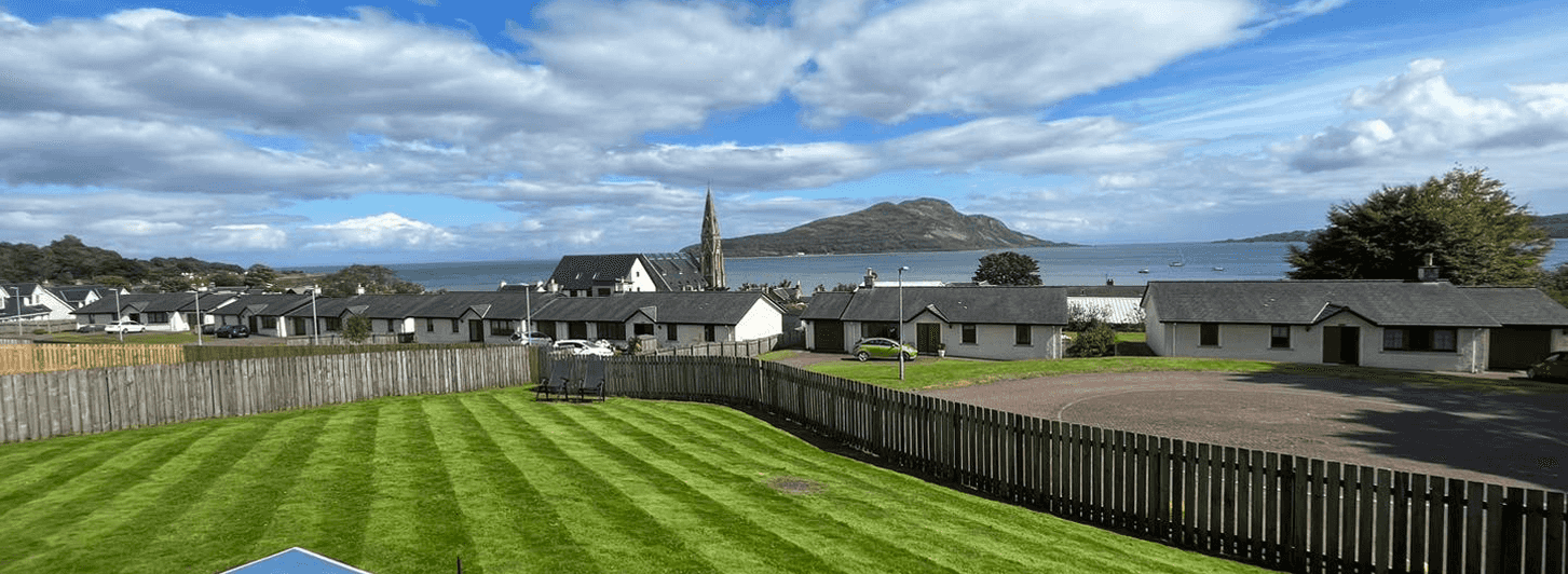A Lovely panoramic view of a lovely small scottish town from the back of a perfectly striped garden finish on a beautiful summers day